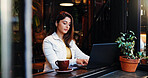 Laptop, remote work and typing with woman in coffee shop for small business planning or research. Computer, review and startup with Indian freelancer in restaurant as customer or entrepreneur
