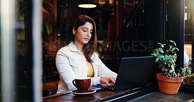 Buy stock photo Laptop, remote work and typing with woman in coffee shop for small business planning or research. Computer, review and startup with Indian freelancer in restaurant as customer or entrepreneur