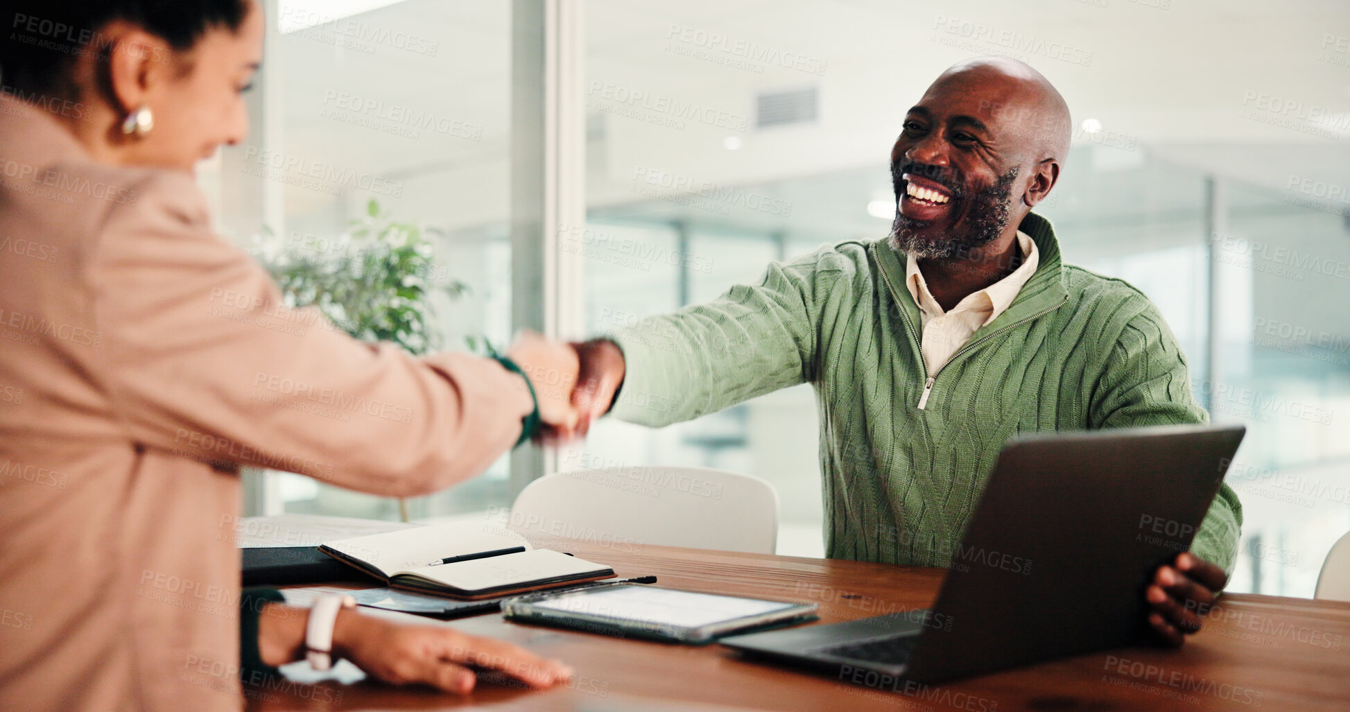 Buy stock photo Business people, handshake and meeting with laptop for hiring, thank you or recruiting in office. Businessman, woman or colleagues shaking hands with smile or technology for onboarding in workplace