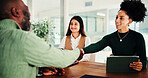 Business man, woman and shaking hands at interview for recruitment, agreement or smile at office. People, manager and handshake with tablet for b2b collaboration, thank you or success at HR agency