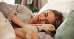Woman, stroke and puppy in home bedroom for rest, nap and relax with comfort and love of pet owner. Tired dog, animal and connection with companionship, security and happy on bed in apartment  