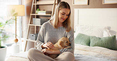 Buy stock photo Smile, woman and relax with puppy in bedroom for love, care and bonding together with companion. Girl, dog mom and stroke pet in bed at home for connection, animal adoption and play with labrador