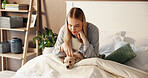 Happy, woman and relax with puppy in bedroom for love, care and bonding together with companion. Girl, dog mom and stroke pet in bed at home for connection, animal adoption and play with labrador