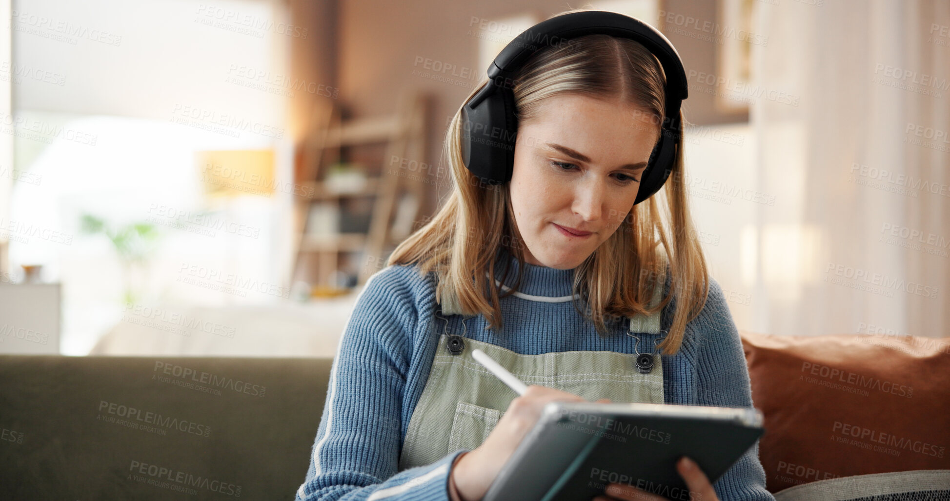 Buy stock photo Tablet, pen and woman with headphones on sofa in home with art, creativity or project for university. Stylus, digital technology and student with music for graphic design assignment for college.