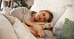 Woman, happy and dog in home bedroom for rest, nap and relax with comfort and love of pet owner. Tired puppy, animal and connection with companionship, security and stroke on bed in apartment  