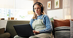 Laptop, headphones and woman on sofa in home with freelance project for creative career with music. Audio tech, computer and female person listening to album for online review with blog in house.