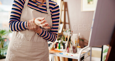 Buy stock photo Hands, wrist pain and woman in studio, painter and carpal tunnel with muscle ache. Inflammation, home and person with bruise, broken and tension with joint injury, arthritis and fatigue with apron