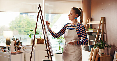 Buy stock photo Woman, artist or painting with canvas in home for artwork, creativity or inspiration in workshop. Female person, drawing or sketching with easel or frame for artistic design, skill or hobby in house