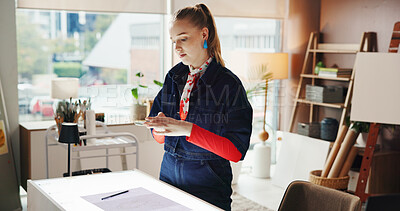 Buy stock photo Painter, smartphone and woman in studio, picture and creativity with social media. Person, content creator and artist with cellphone, home or update website for online portfolio or showcase talent