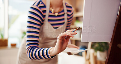 Buy stock photo Painting, art and hand of woman in studio for creative, watercolor paintbrush and talent. Easel, sketch and canvas drawing with person in painter workshop for artist process, color and hobby