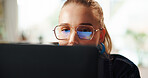 Woman, glasses and reading on laptop at house for research, editing article and feedback. Female journalist, pc and reflection for story information, proofreading headline and schedule of publication