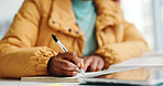 Student, hands and writing in book at university for exam study, research or tutorial assignment. Campus, education and person with memory notes for assessment, college quiz and learning evaluation