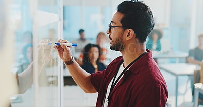 Buy stock photo College, classroom and teacher writing on whiteboard for lesson, learning and education at school. University, lecturer and man with notes for students for knowledge, assignment and teaching course