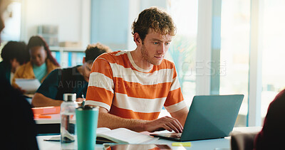 Buy stock photo Laptop, college and typing with man in classroom for software bootcamp, web developer and research. Programmer course, coding scholarship and studying with male person on campus for tech lecture