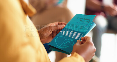 Buy stock photo Hands, person and reading brochure in therapy for mental health info, treatment options or about us. Psychology, patient and leaflet in counseling for support resources, education or stigma reduction