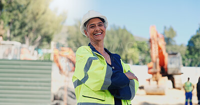 Buy stock photo Woman, engineer and arms crossed at construction site with smile, portrait and pride for property development. Mature person, architect and technician with helmet, happy and real estate expansion