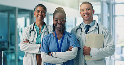 Buy stock photo Doctors, team and arms crossed in portrait, happy and pride for medical career in hospital corridor. Healthcare professional, women and man with solidarity, smile and services at wellness clinic
