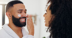 House, cream and couple in bathroom, help and wellness with skincare, dermatology and lotion. Healing cosmetics, sunscreen or man with woman, relationship and healthy skin with support or grooming