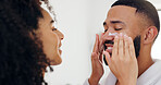 Home, cream and couple in bathroom, help and wellness with skincare, dermatology and relationship. Healing cosmetics, sunscreen or man with woman, grooming and healthy skin with support or lotion