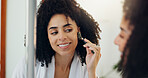 Woman, mirror and roller for skincare at house for grooming, lymphatic drainage and natural beauty. Smile, female person and reflection with jade cosmetics, facial massage and dermatology benefits
