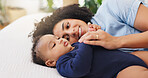Mother, relax and playing with baby on bed for bonding together, motherhood or connection. Love, happy family and woman cuddle with infant in home for protection, morning routine or child development