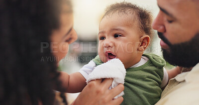 Buy stock photo Home, cloth and parent with baby, love and bonding together with care, support and wellness. Family, apartment or mother with father, infant or cleaning face with hygiene, newborn or help with growth