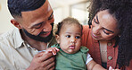 Parents, baby and happy with care, home and connection with holding hands for love in living room. People, mother and father with infant child, touch or smile with comfort for bonding at family house