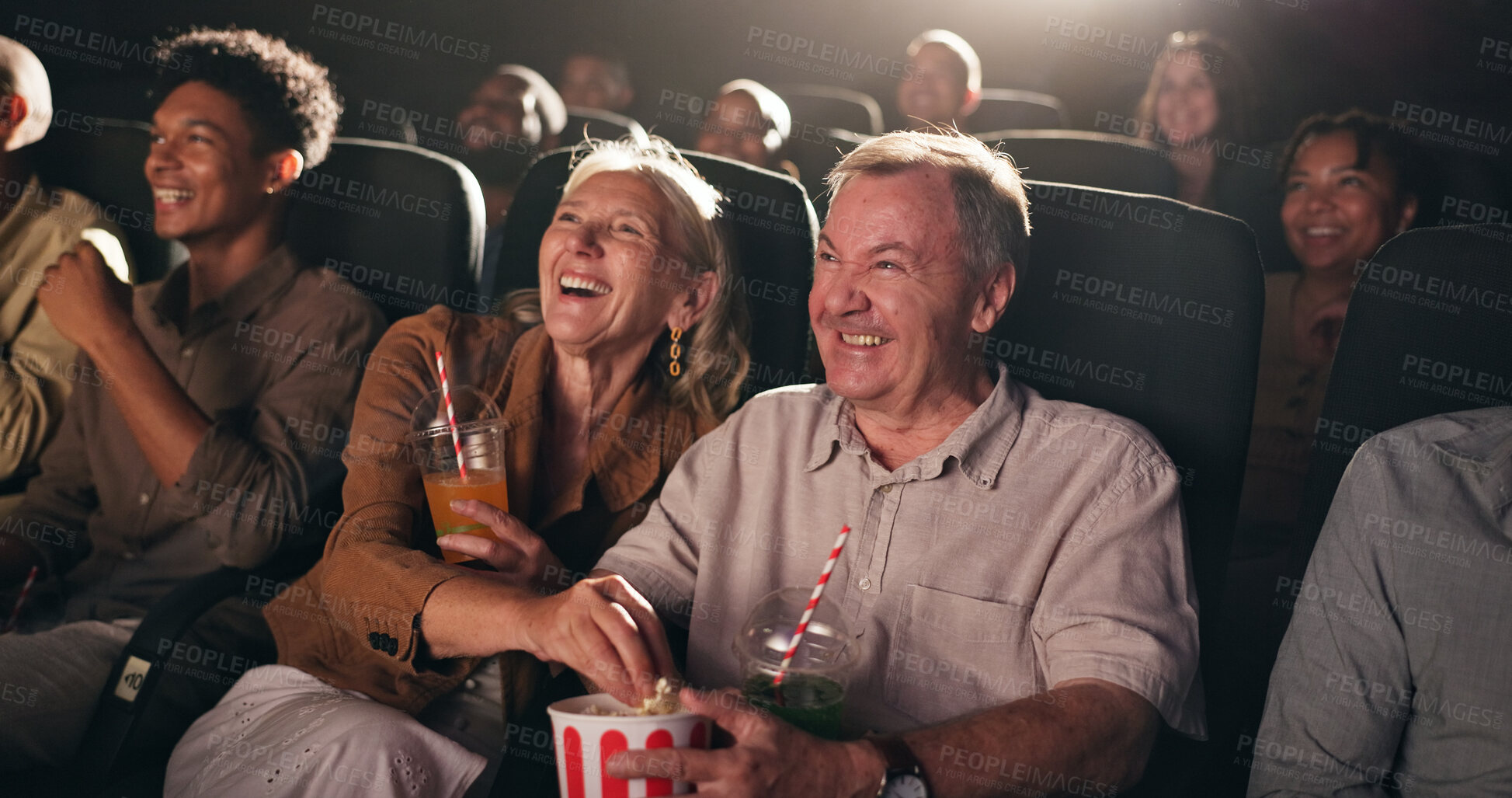 Buy stock photo Senior couple, popcorn and happy at cinema for movie in crowd, bonding and date with comedy show. Elderly people, laugh and excited with fast food, snack or relax with comic film screening at theater