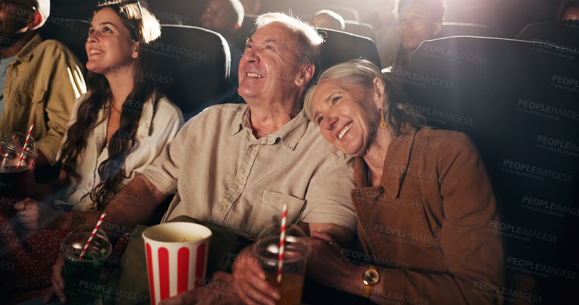 Buy stock photo Senior couple, laugh and happy at cinema for movie in crowd, bonding and date with comedy show. Elderly people, smile and excited with fast food, popcorn and watch comic film with love at theater
