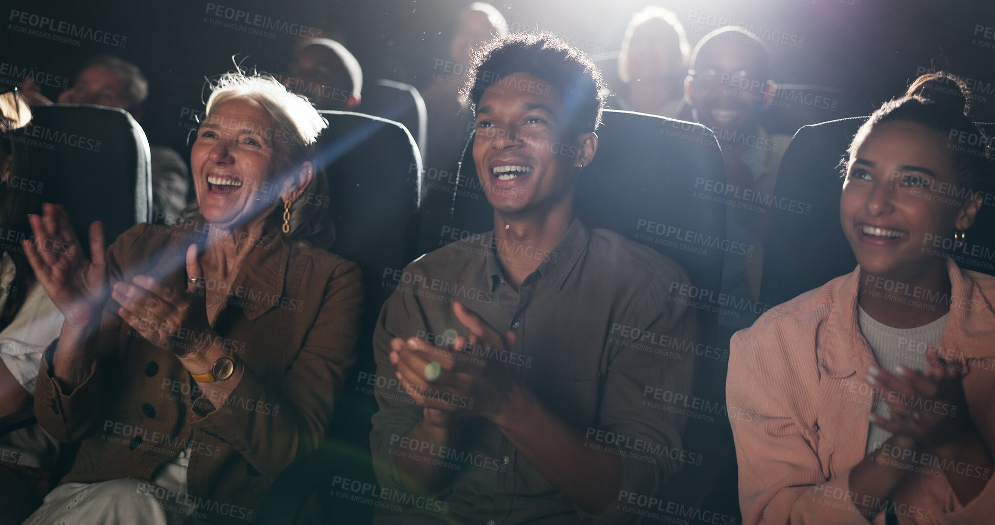 Buy stock photo Applause, happy and audience in theatre for movie, comedy show and reaction for film in cinema. Laughing, entertainment and group of men and women for motion picture, premiere success and approval