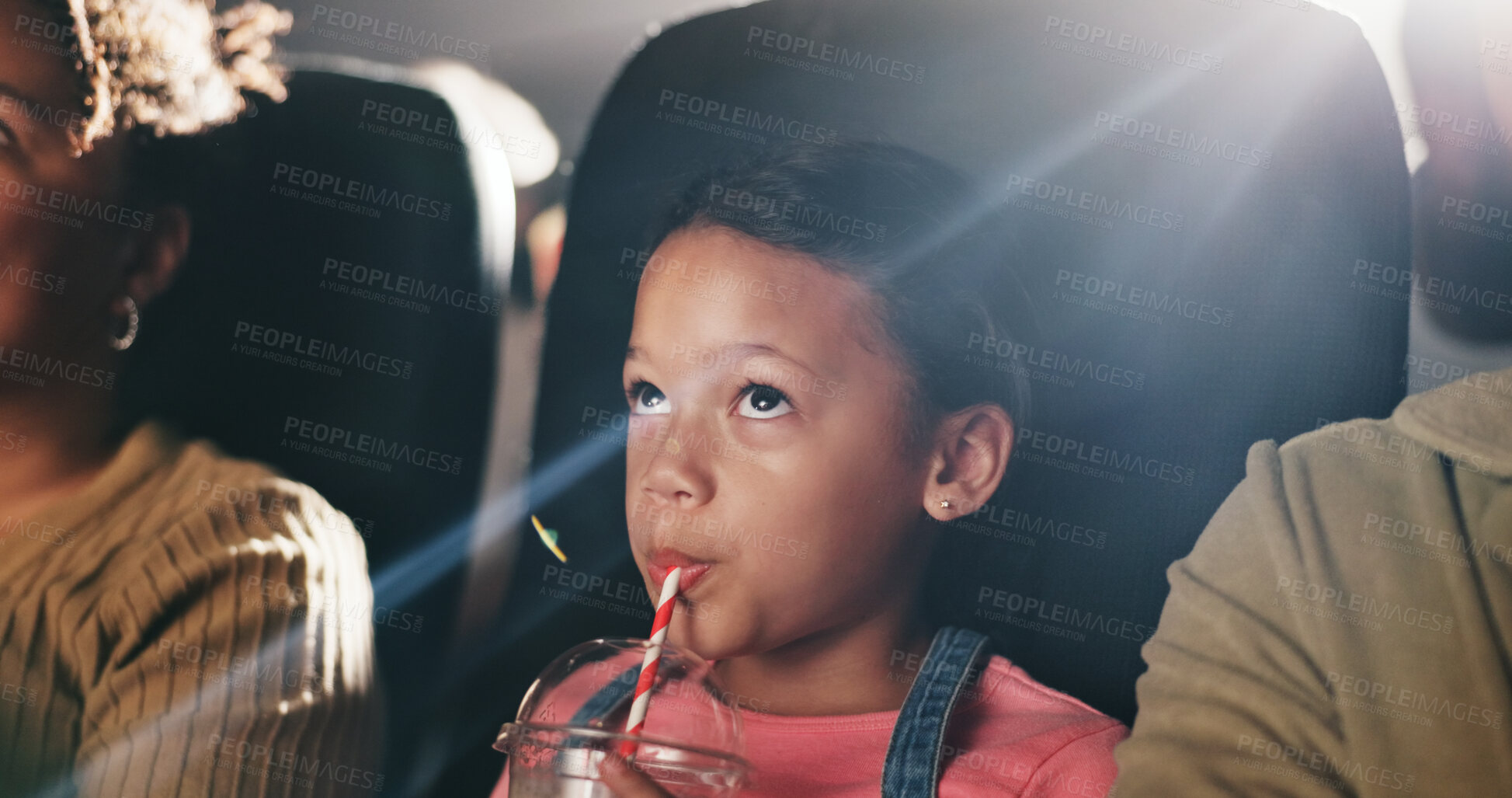 Buy stock photo Movie, theatre and child with drink in cinema for entertainment, experience and watching cartoon. Family, parents and girl with snacks for screening, animation and film audience for production