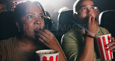 Buy stock photo Couple, popcorn and horror movie at theater with snack, date and entertainment at film screening. People, man and woman with shock for thriller in crowd, spooky show or scared with fear at cinema