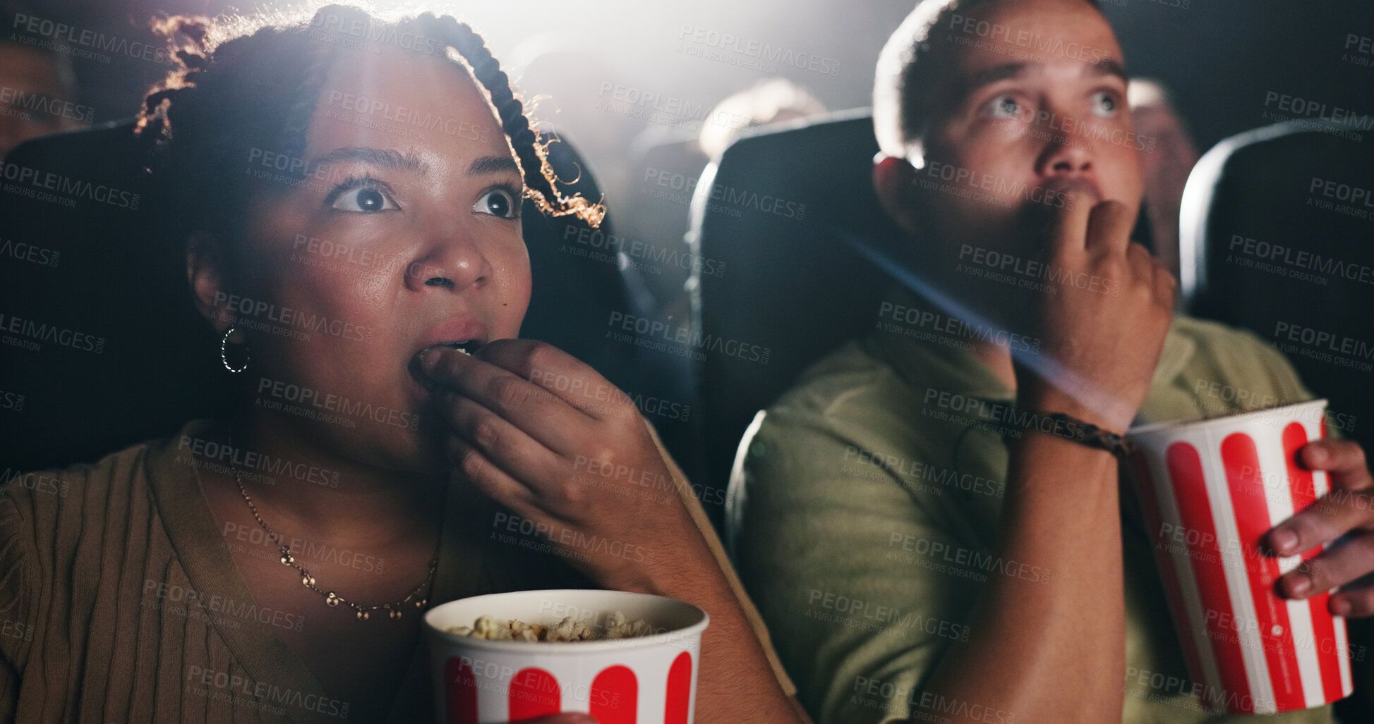 Buy stock photo Couple, popcorn and horror movie at theater with snack, date and entertainment at film screening. People, man and woman with shock for thriller in crowd, spooky show or scared with fear at cinema