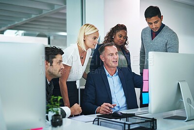 Buy stock photo Shot of corporate colleagues working together in their office