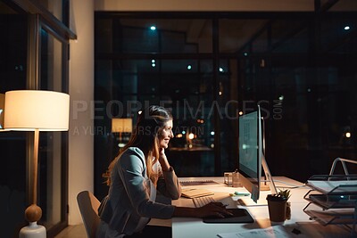 Buy stock photo Shot of a young businesswoman using a computer during a late night at work