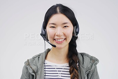 Buy stock photo Portrait, woman and headset with smile for call centre, communication and pride by white background. Asian female person, happiness and microphone for talking, crm agent and consultant in studio