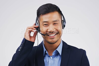 Buy stock photo Asian man, thinking and call center in studio with smile, headset and happy on white background. Male person, consultant and advisor for support, information and crm with mic for communication
