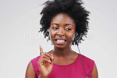 Buy stock photo Black woman, talking or listening with headset in studio background for consultant, call centre or crm. Female person, conversation and headphones with mic for support, connectivity and communication