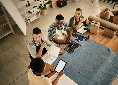 Buy stock photo Fashion designers, colleagues and creatives meeting to discuss and brainstorm a clothing range in a workshop from above. Team planning garment designs in a textile and manufacturing studio or factory