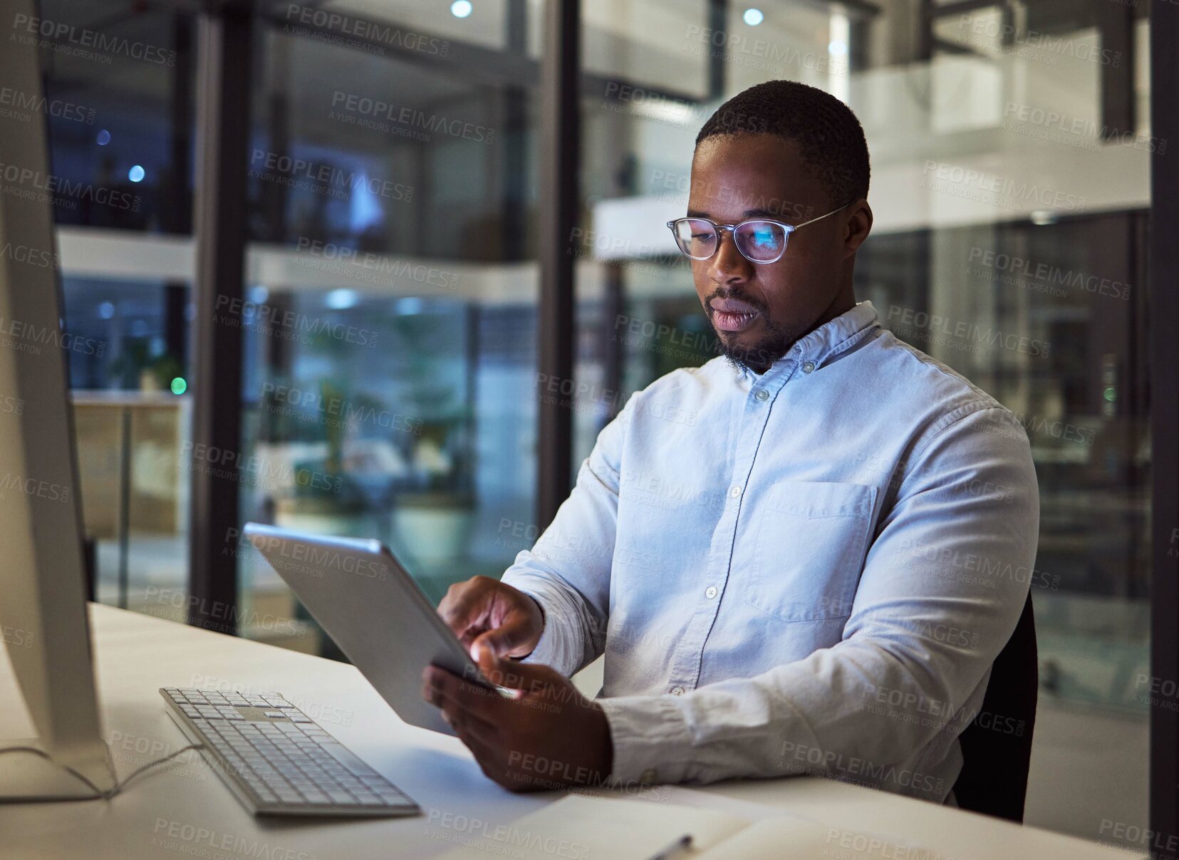 Buy stock photo Black businessman, tablet and data analysis with computer in night office for digital marketing software, cybersecurity code or kpi. Thinking programmer, developer or website designer with technology