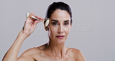 Buy stock photo Derma roller, portrait and skincare with woman in studio for antiaging cosmetics or dermatology. Beauty, gua sha and massage with person isolated on gray background for crystal stone face treatment
