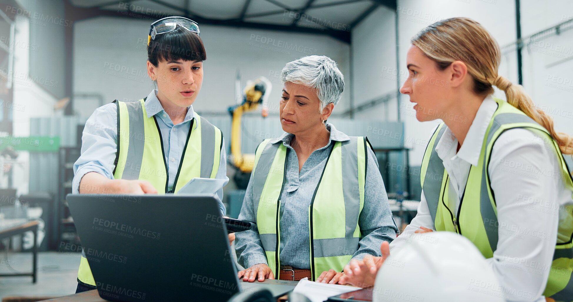 Buy stock photo Engineer women, teamwork and laptop in meeting for planning, discussion or communication at factory. Female employees, collaboration and problem solving for robotics with software programming