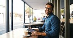 Laptop, portrait and remote work with man in cafe to research for small business startup. Computer, smile and website with freelance employee in booth of coffee shop or restaurant as customer