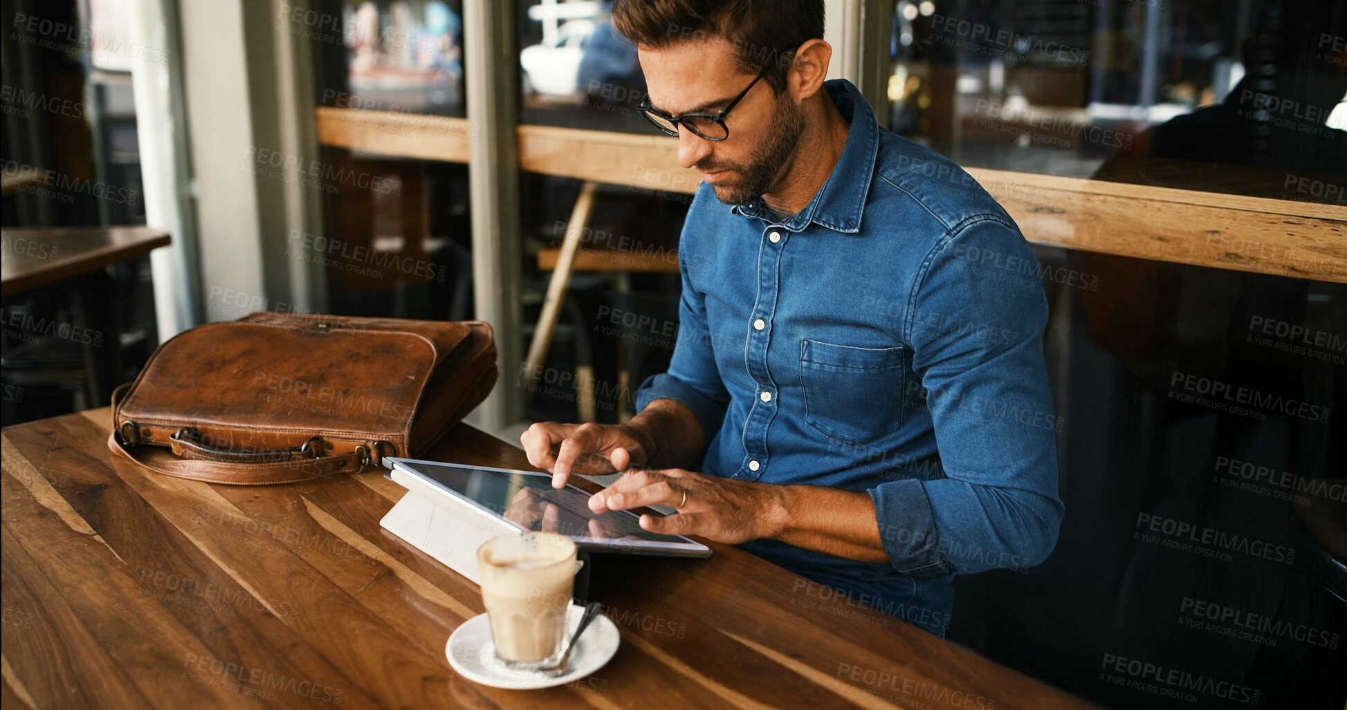 Buy stock photo Business, man and typing on tablet at cafe for online research, coffee break and remote work. Freelancer, person and scroll on digital tech at bistro for networking, calendar app and check schedule