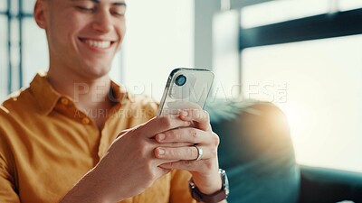 Buy stock photo Hands, phone and relax with man on sofa in living room of home for break or internet browsing. App, social media and text message with smile of person in apartment for communication or connection