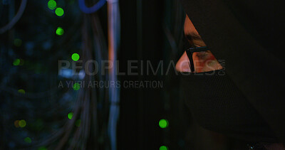 Buy stock photo Night, hacker and person with mask by cables for scam, phishing or cybercrime for online attack. Anonymous, privacy and programmer with security breach, server or database encryption in control room.