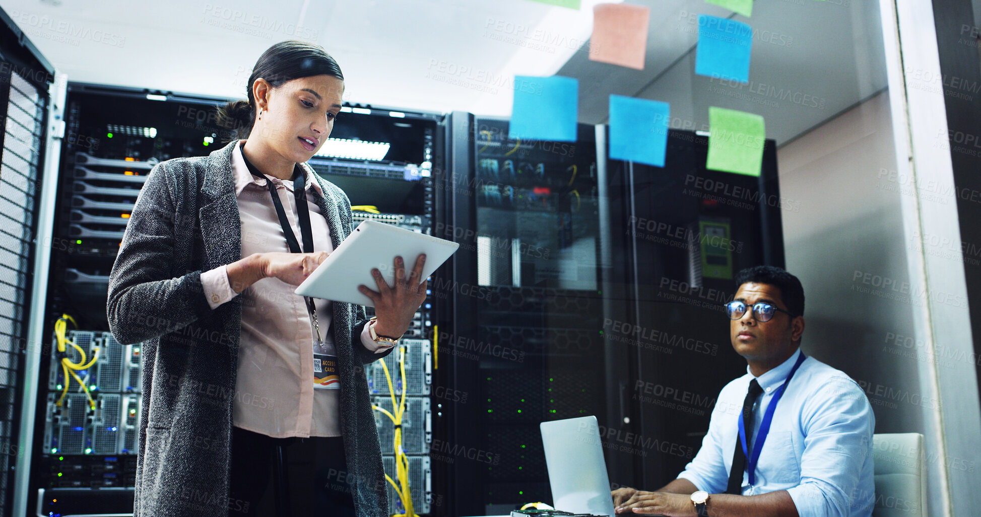 Buy stock photo Woman, tablet and talk with man in server room, programming or glass wall for IT solution at company. People, planning and talk with tech, application or information technology for system maintenance