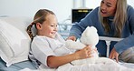 Teddy bear, playing and mother with child in hospital with visit for support, bonding or recovery. Smile, fluffy toy and mom having fun with girl kid for healthcare checkup in medical clinic.