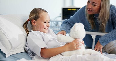 Buy stock photo Teddy bear, playing and mother with child in hospital with visit for support, bonding or recovery. Smile, fluffy toy and mom having fun with girl kid for healthcare surgery in medical clinic.