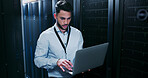 Data center, cybersecurity and man with laptop, typing and  network engineer with tech for software. Server room, IT specialist and person with computer for firmware upgrade, serious and maintenance